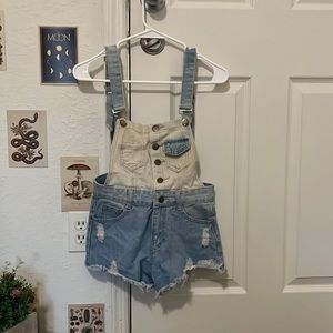 Cute little pair of light wash overalls. Size Small.